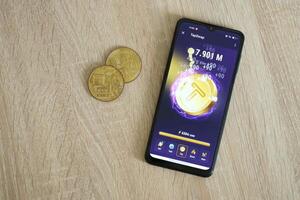 KYIV, UKRAINE - APRIL 20, 2024 Tap Swap telegram bot on smartphone screen. Tap Swap is a viral Telegram based crypto game for earn tokens by managing virtual crypto exchange photo