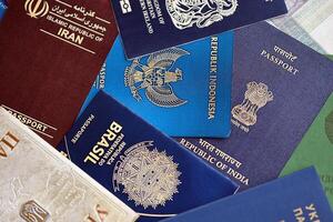 Many various passports of citizens of different countries and regions of the world photo