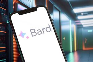 KYIV, UKRAINE - MARCH 17, 2024 Google Bard logo on iPhone display screen with background of artificial intelligence futuristic image photo