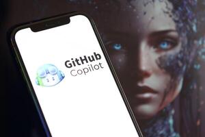 KYIV, UKRAINE - MARCH 17, 2024 Github copilot logo on iPhone display screen with background of artificial intelligence futuristic image photo