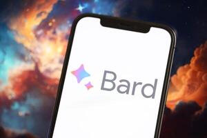 KYIV, UKRAINE - MARCH 17, 2024 Google Bard logo on iPhone display screen with background of artificial intelligence futuristic image photo