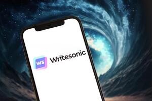 KYIV, UKRAINE - MARCH 17, 2024 Writesonic logo on iPhone display screen with background of artificial intelligence futuristic image photo