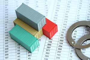 Global business container cargo ship in import export business logistic and handcuffs photo