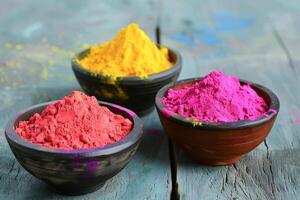 Vibrant Collection of Powdered Holi Colors in Traditional Bowls on Dark Background photo