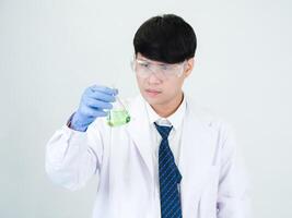 Portrait asian man student scientist or doctor look hand holding reagent mixing laboratory in science research laboratory with test tubes of various size in laboratory chemistry lab white background photo