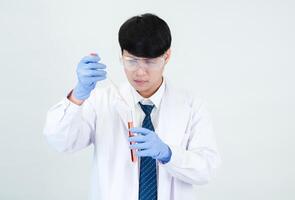 Portrait asian man student scientist or doctor look hand holding reagent mixing laboratory in science research laboratory with test tubes of various size in laboratory chemistry lab white background photo