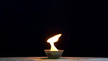 Flames are burning in a bowl isolated on a black background. Concept of particles, sparkles, flame and light. video