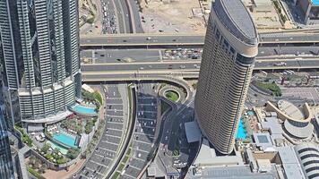 UAE, Dubai 01 May 2024 Aerial View of Urban Highways and Modern Buildings. A detailed aerial view of urban highways and modern high-rise buildings, showcasing the intricate layout of roads and video