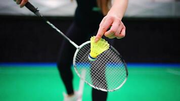 Close up view of racket and shuttlecock, practicing serve before playing in badminton on inside court. High quality 4k footage video