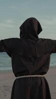 Religious Monk With Prays Towards The Sea With Open Arms video