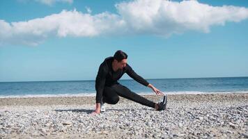 Gymnic Boy Does Stretching On The Beach Near The Ocean video