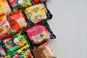 KYIV, UKRAINE - OCTOBER 31, 2023 Many packs of instant noodles for fast cooking by various brands and manufacturers photo