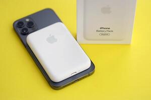 KYIV, UKRAINE - OCTOBER 31, 2023 Apple MagSafe battery device for iPhone charging via magnet connection. Mag Safe modern portable power bank photo