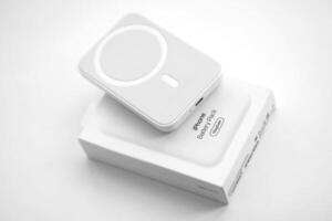 KYIV, UKRAINE - OCTOBER 31, 2023 Apple MagSafe battery device for iPhone charging via magnet connection. Mag Safe modern portable power bank photo