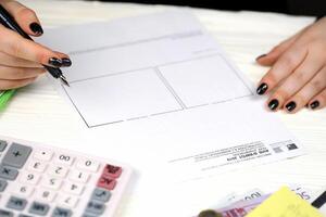 KYIV, UKRAINE - OCTOBER 31, 2023 Accountant fill french tax form Notice of housing tax in end of tax period. Taxation and paperwork routine photo