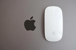 KYIV, UKRAINE - NOVEMBER 27, 2023 Apple Magic Mouse 3rd generation lies with grey MacBook 2021 photo