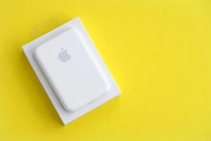 KYIV, UKRAINE - OCTOBER 31, 2023 Apple MagSafe battery device for iPhone charging via magnet connection. Mag Safe modern portable power bank photo