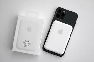 KYIV, UKRAINE - OCTOBER 31, 2023 Apple MagSafe battery device for iPhone charging via magnet connection. Mag Safe modern portable power bank photo