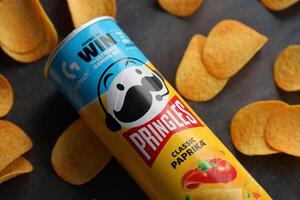 KYIV, UKRAINE - 4 MAY, 2023 Pringles tube of chips with rare classic paprika flavour photo