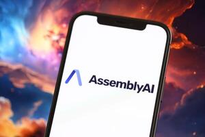 KYIV, UKRAINE - MARCH 17, 2024 AssemblyAI logo on iPhone display screen with background of artificial intelligence futuristic image photo