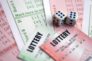 Green and red lottery tickets with dice on blank bills with numbers for playing lottery photo