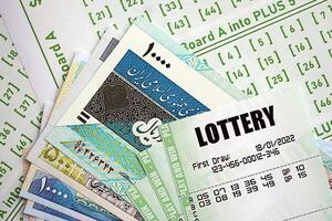 Green lottery tickets and iranian money bills on blank with numbers for playing lottery photo