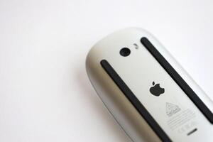 KYIV, UKRAINE - NOVEMBER 27, 2023 Apple Magic Mouse 3rd generation lies on white background photo