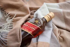 KYIV, UKRAINE - NOVEMBER 27, 2023 Johnnie Walker red label scotch whisky bottle photo