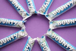 KYIV, UKRAINE - OCTOBER 31, 2023 Bounty chocolate bars with cocoa flavor filling. Bounty chocolate bar is a brand of American Mars Inc photo