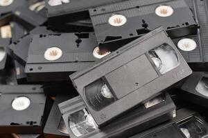 KYIV, UKRAINE - 4 MAY, 2023 tape on colored background, VHS, cassette. Messy stack of VHS tapes. Home System tape photo
