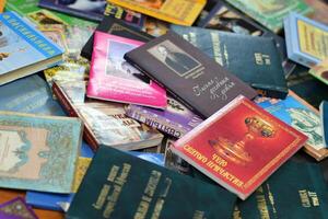 KYIV, UKRAINE - 4 MAY, 2023 Christian slavonic religious book stacked on table in chaotic order photo
