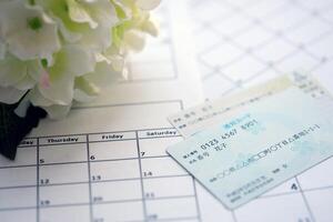 Japanese my number card specimen and notification card on calendar background photo
