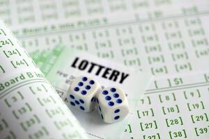 Lottery tickets and dice on blank bills with numbers for playing lottery photo