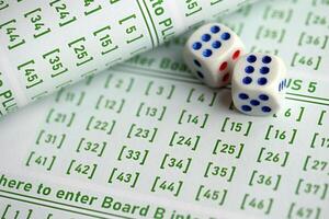 Lottery tickets and dice on blank bills with numbers for playing lottery photo