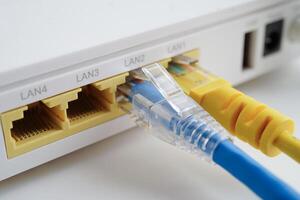 Ethernet cable with wireless router connect to internet service provider network. photo