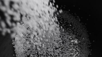 Filling the tank with plastic granules. The process of producing parts from polyethylene compound. White granules are poured into a container. video