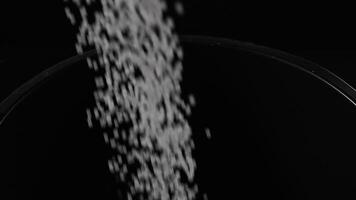Filling the tank with plastic granules. The process of producing parts from polyethylene compound. White granules are poured into a container. video