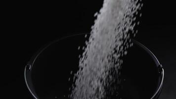 Filling the tank with plastic granules. The process of producing parts from polyethylene compound. White granules are poured into a container. video