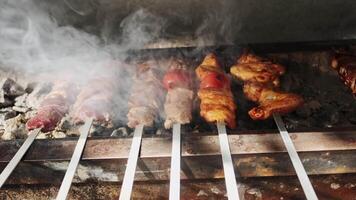 Chicken, meat and liver kebabs are fried on an open grill with charcoal video