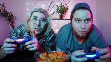 Two friends are playing on a game console using a joystick. They lose and are upset. video