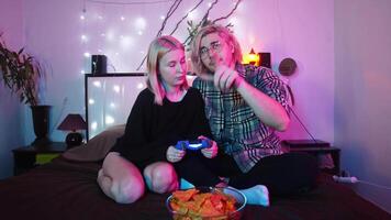 Man explains to his partner how to use a game controller for a game console. video