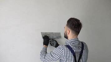 Man plasterer construction worker at work, plastering the wall inside the building site of a house video