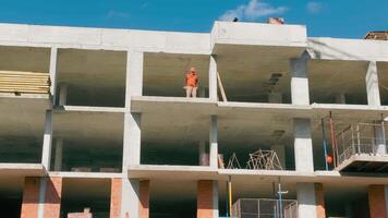 A Builder Stands On The Edge Of A Multi-story Building And Inspects The Construction. House Under Construction video