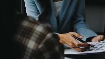 Financial analysts analyze business financial reports on a digital tablet planning investment project during a discussion at a meeting of corporate showing the results of their successful teamwork. video