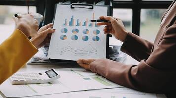 Financial analysts analyze business financial reports on a digital tablet planning investment project during a discussion at a meeting of corporate showing the results of their successful teamwork. video