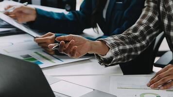 Financial analysts analyze business financial reports on a digital tablet planning investment project during a discussion at a meeting of corporate showing the results of their successful teamwork. video