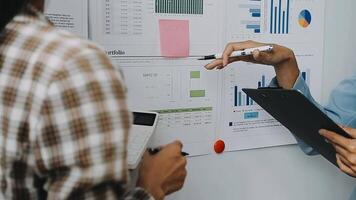 Close up Business woman using calculator and laptop for do math finance on wooden desk in office and business working background, tax, accounting, statistics and analytic research concept video