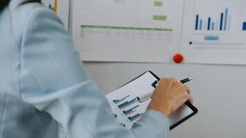 Financial analysts analyze business financial reports on a digital tablet planning investment project during a discussion at a meeting of corporate showing the results of their successful teamwork. video