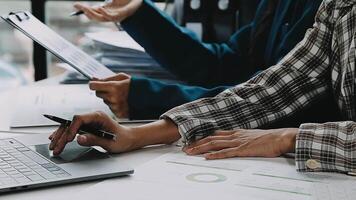 Financial analysts analyze business financial reports on a digital tablet planning investment project during a discussion at a meeting of corporate showing the results of their successful teamwork. video