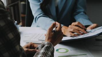 Financial analysts analyze business financial reports on a digital tablet planning investment project during a discussion at a meeting of corporate showing the results of their successful teamwork. video